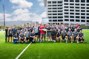 Col. Andrew C. Dermanoski, commander of Space Base Delta 3, presents the championship belt to members of Space Systems Delta 89 after they placed first during Los Angeles Air Force Base’s 2026 Sports Day at Da Vinci School in El Segundo, California, July 1, 2026.