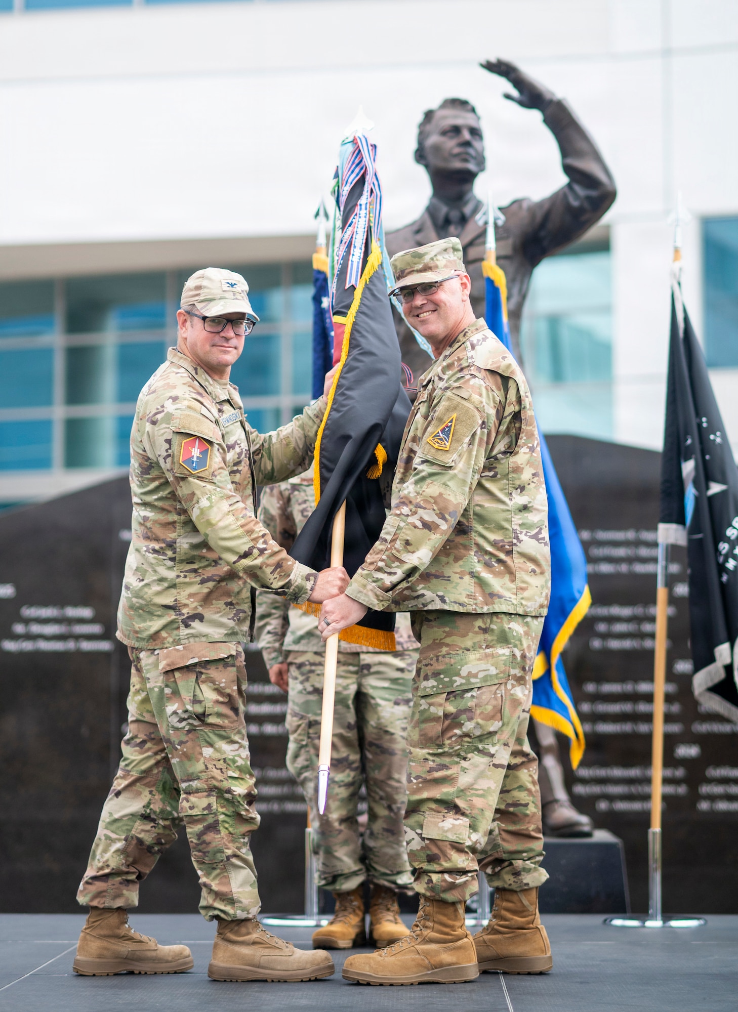 U.S. Space Force Col. Andrew C. Dermanoski, commander of Space Base Delta 3, left, presents the SBD 3 guidon to U.S. Air Force Chief Master Sgt. Michael Deiderich, incoming SBD 3 command chief, during a change of responsibility ceremony at Los Angeles Air Force Base in El Segundo, California, June 30, 2026.