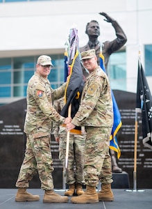U.S. Space Force Col. Andrew C. Dermanoski, commander of Space Base Delta 3, left, presents the SBD 3 guidon to U.S. Air Force Chief Master Sgt. Michael Deiderich, incoming SBD 3 command chief, during a change of responsibility ceremony at Los Angeles Air Force Base in El Segundo, California, June 30, 2026.