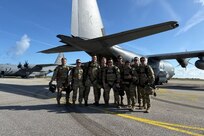 Combat rescue officers and pararescuemen of 212th Rescue Squadron stand in front of a 211th Rescue Squadron HC-130J Combat King II combat search and rescue aircraft during the 82nd D-Day anniversary in Normandy, France. The Alaska Air National Guard Airmen jumped with the Air Force and U.S. Army to commemorate the cross-channel invasion.