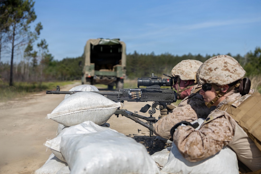 U.S. Marine Corps First Sgt. Jennifer Quinn, senior enlisted advisor, right, and Lance Cpl. Jude E. Griffith, combat engineer, both with Marine Wing Support Squadron 273, Marine Air Control Group 28, 2nd Marine Aircraft Wing, fire an M240B machine gun while conducting a field exercise at Townsend Bombing Range, Georgia, May 6, 2026. This FEX was conducted to sustain MWSS-273’s proficiency in mission-essential tasks and increase readiness for the upcoming Weapons and Tactics Instructor course 1-27. (U.S. Marine Corps photo by Cpl. Isabella L. Renaud)