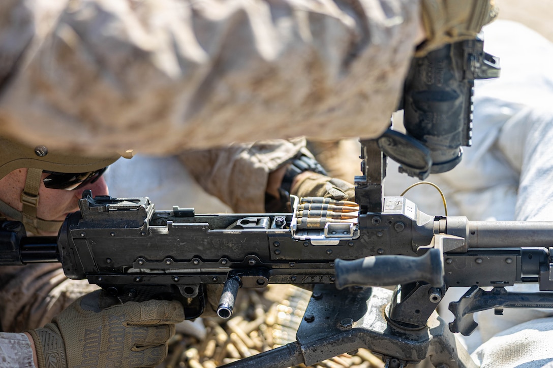 U.S. Marine Corps Lance Cpl. Jude E. Griffith, combat engineer, Marine Wing Support Squadron 273, Marine Air Control Group 28, 2nd Marine Aircraft Wing, loads an M240B machine gun while conducting a field exercise at Townsend Bombing Range, Georgia, May 6, 2026. This FEX was conducted to sustain MWSS-273’s proficiency in mission-essential tasks and increase readiness for the upcoming Weapons and Tactics Instructor course 1-27. (U.S. Marine Corps photo by Cpl. Isabella L. Renaud)