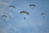 Paratroopers from the U.S. Army and Air Force execute a military free fall into a drop zone at La Fiere, France, June 07, 2026. D-Day 82 commemorates the courage and sacrifice of Allied forces who fought for freedom, reminding us of the enduring strength of alliances and shared responsibility.