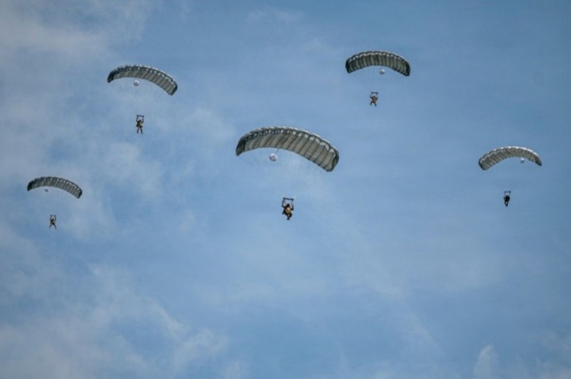 Paratroopers from the U.S. Army and Air Force execute a military free fall into a drop zone at La Fiere, France, June 07, 2026. D-Day 82 commemorates the courage and sacrifice of Allied forces who fought for freedom, reminding us of the enduring strength of alliances and shared responsibility.