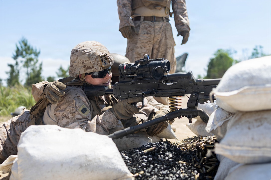 U.S. Marine Corps First Sgt. Jennifer Quinn, senior enlisted advisor, Marine Wing Support Squadron 273, Marine Air Control Group 28, 2nd Marine Aircraft Wing, left, fires an M240B machine gun while conducting a field exercise at Townsend Bombing Range, Georgia, May 6, 2026. This FEX was conducted to sustain MWSS-273’s proficiency in mission-essential tasks and increase readiness for the upcoming Weapons and Tactics Instructor course 1-27. (U.S. Marine Corps photo by Cpl. Isabella L. Renaud)