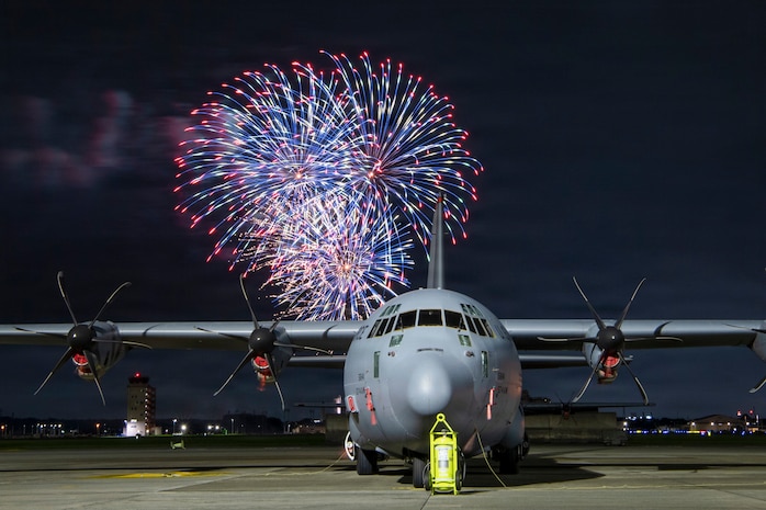 Fireworks burst behind a C-130J Super Hercules assigned to the 36th Airlift Squadron during Celebrate America at Yokota Air Base, Japan, July 4, 2026.
