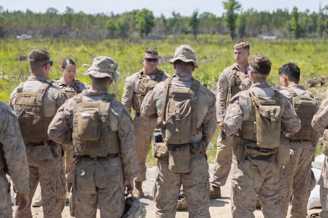 U.S. Marine Corps Gunnery Sgt. Zachary S. Wilkinson, branch chief, Marine Wing Support Squadron 273, Marine Air Control Group 28, 2nd Marine Aircraft Wing, center, speaks with Marines after conducting a field exercise at Townsend Bombing Range, Georgia, May 6, 2026. This FEX was conducted to sustain MWSS-273’s proficiency in mission-essential tasks and increase readiness for the upcoming Weapons and Tactics Instructor course 1-27. (U.S. Marine Corps photo by Cpl. Isabella L. Renaud)