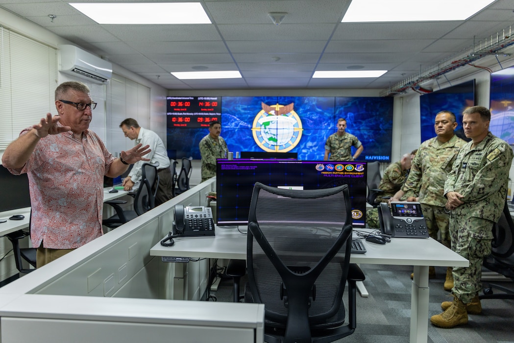 Jack Miller, First Island Chain Integrator, Pacific Multi-Domain Training and Experimentation Capability, provides military leaders with a tour of the PMTEC Forward-Guam facility following a ribbon-cutting ceremony at Building 4175 on U.S. Naval Base Guam, June 22, 2026.