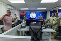 Jack Miller, First Island Chain Integrator, Pacific Multi-Domain Training and Experimentation Capability, provides military leaders with a tour of the PMTEC Forward-Guam facility following a ribbon-cutting ceremony at Building 4175 on U.S. Naval Base Guam, June 22, 2026.