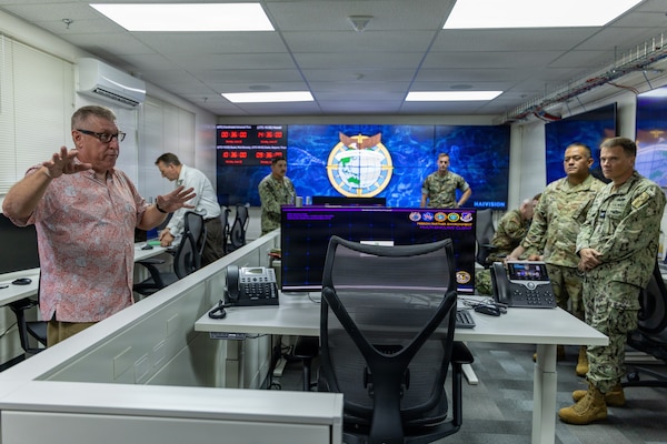 Jack Miller, First Island Chain Integrator, Pacific Multi-Domain Training and Experimentation Capability, provides military leaders with a tour of the PMTEC Forward-Guam facility following a ribbon-cutting ceremony at Building 4175 on U.S. Naval Base Guam, June 22, 2026.