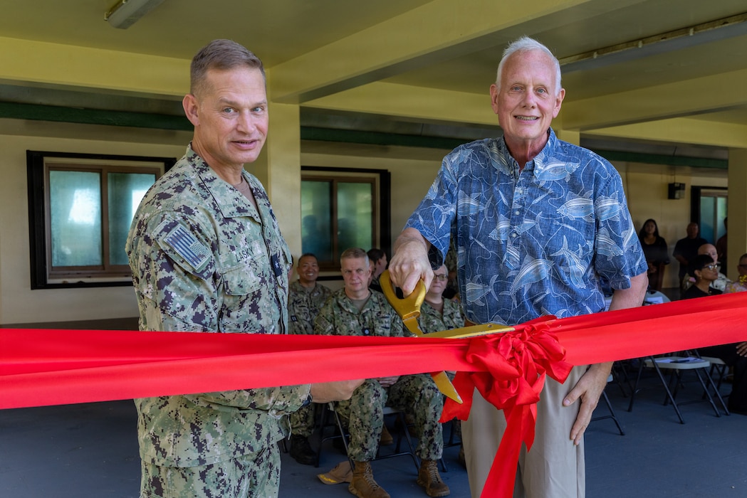 U.S. Navy Rear Adm. Josh Lasky, Commander, Joint Task Force-Micronesia, and Dr. John Wood, U.S. Pacific Command’s J7 Training and Exercises Deputy Director, perform a ribbon-cutting for the Pacific Multi-Domain Training and Experimentation Capability Forward - Guam facility during a ceremony at Building 4175 on U.S. Naval Base Guam, June 22, 2026.
