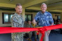 U.S. Navy Rear Adm. Josh Lasky, Commander, Joint Task Force-Micronesia, and Dr. John Wood, U.S. Pacific Command’s J7 Training and Exercises Deputy Director, perform a ribbon-cutting for the Pacific Multi-Domain Training and Experimentation Capability Forward - Guam facility during a ceremony at Building 4175 on U.S. Naval Base Guam, June 22, 2026.