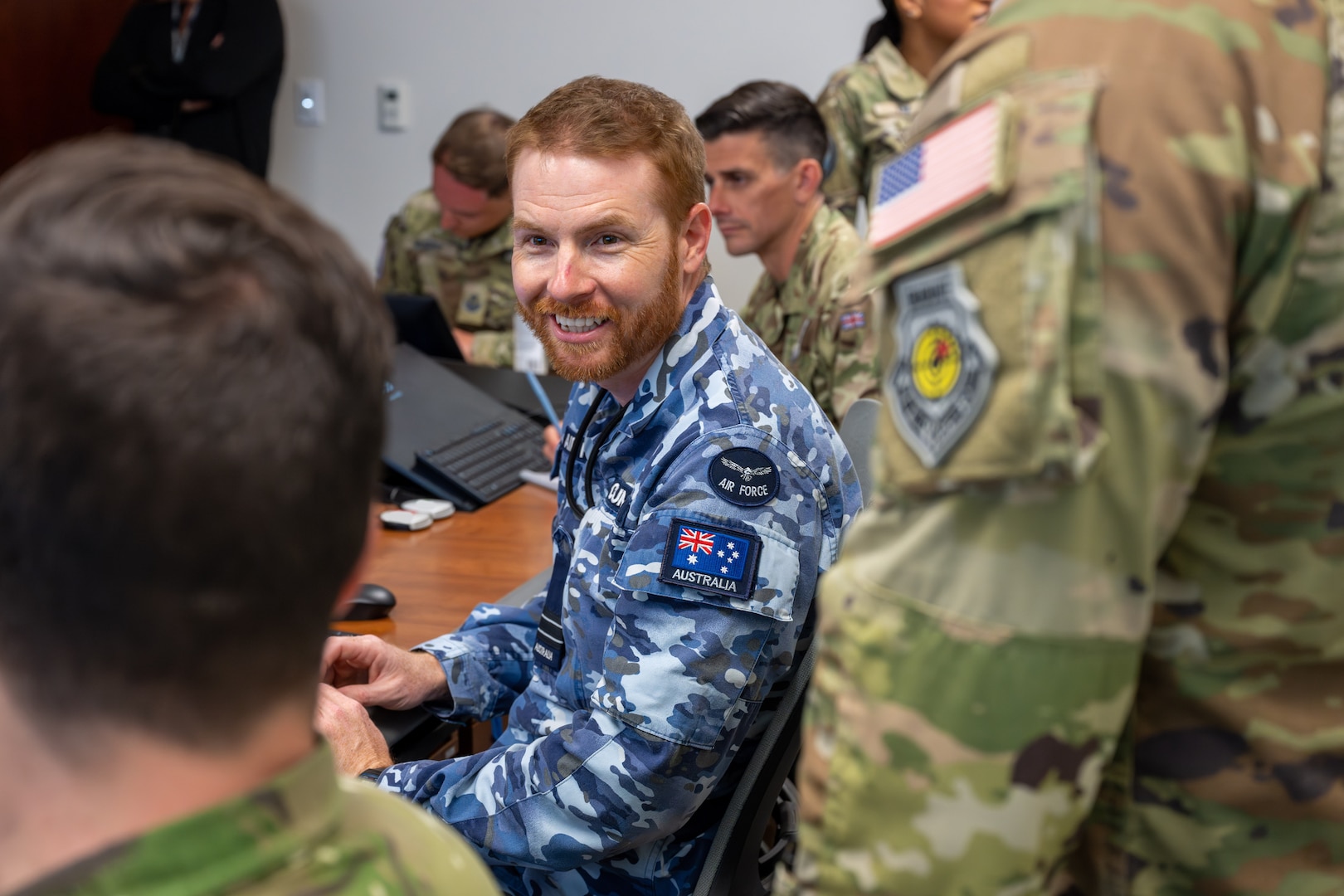 Military members and civilians work at training event.