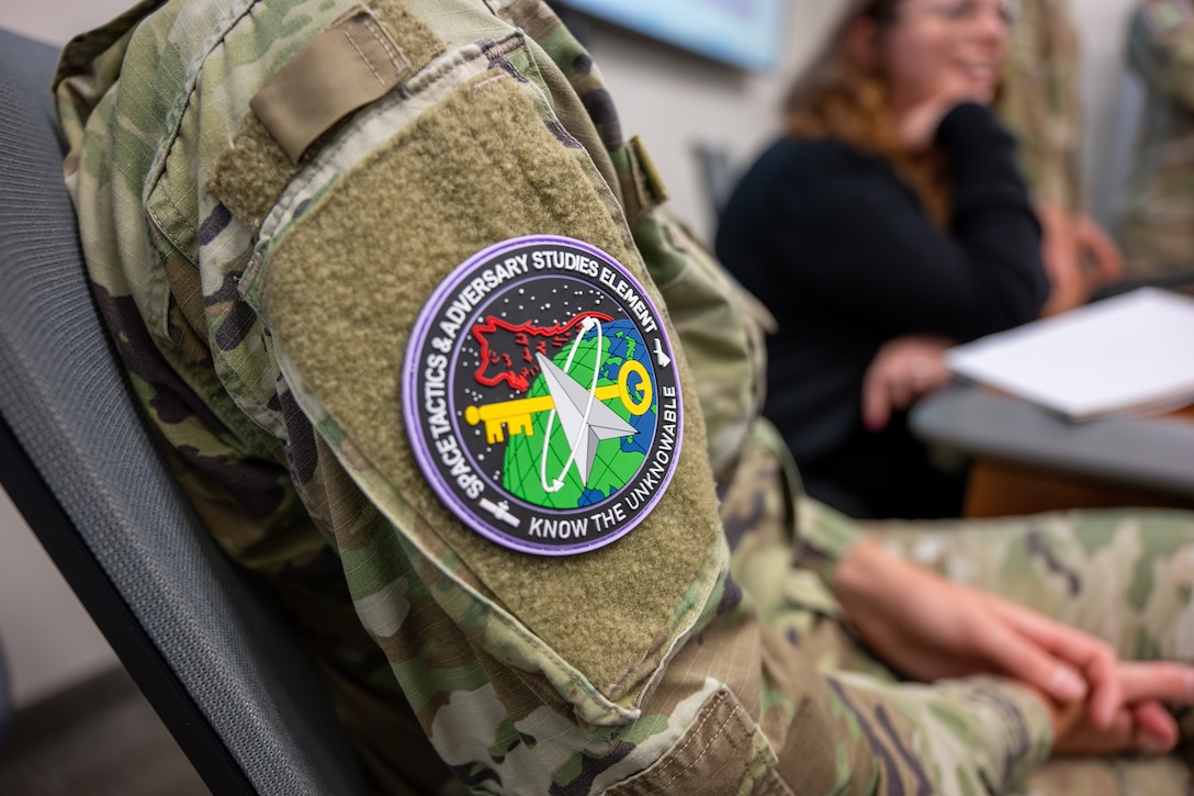 Military members and civilians work at training event.