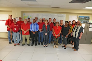 Photo shows group of people standing together for photo.