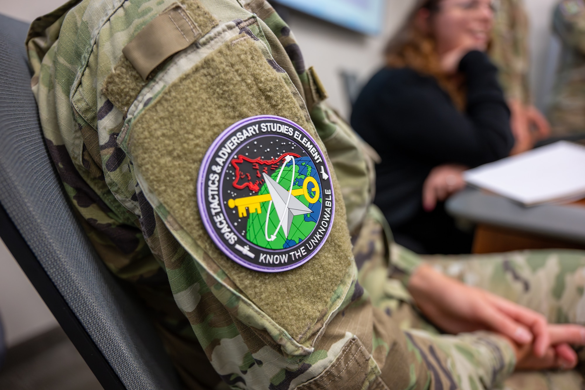 Military members and civilians work at training event.