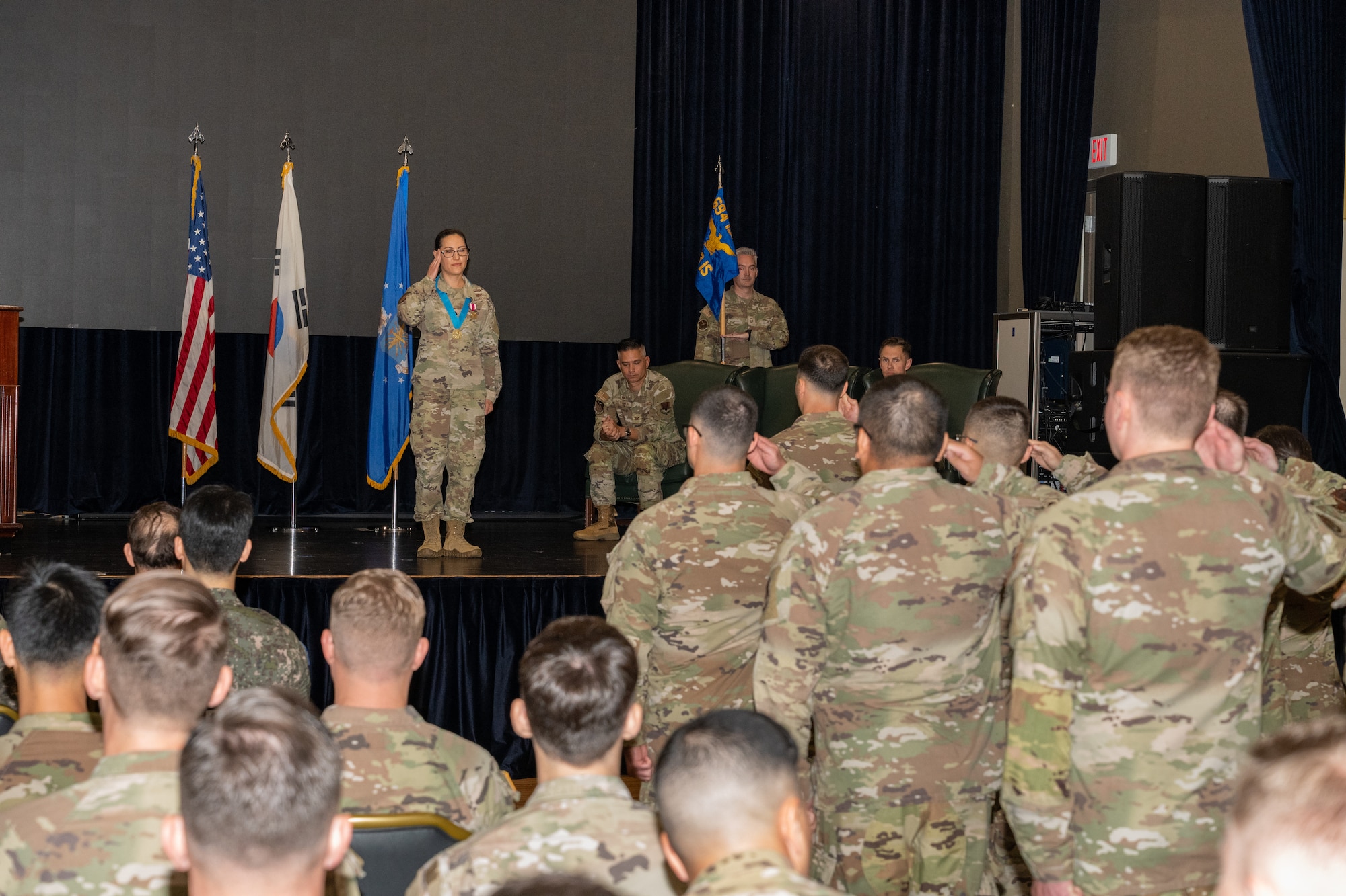 Airmen salute an outgoing commander for the final time during a ceremony.