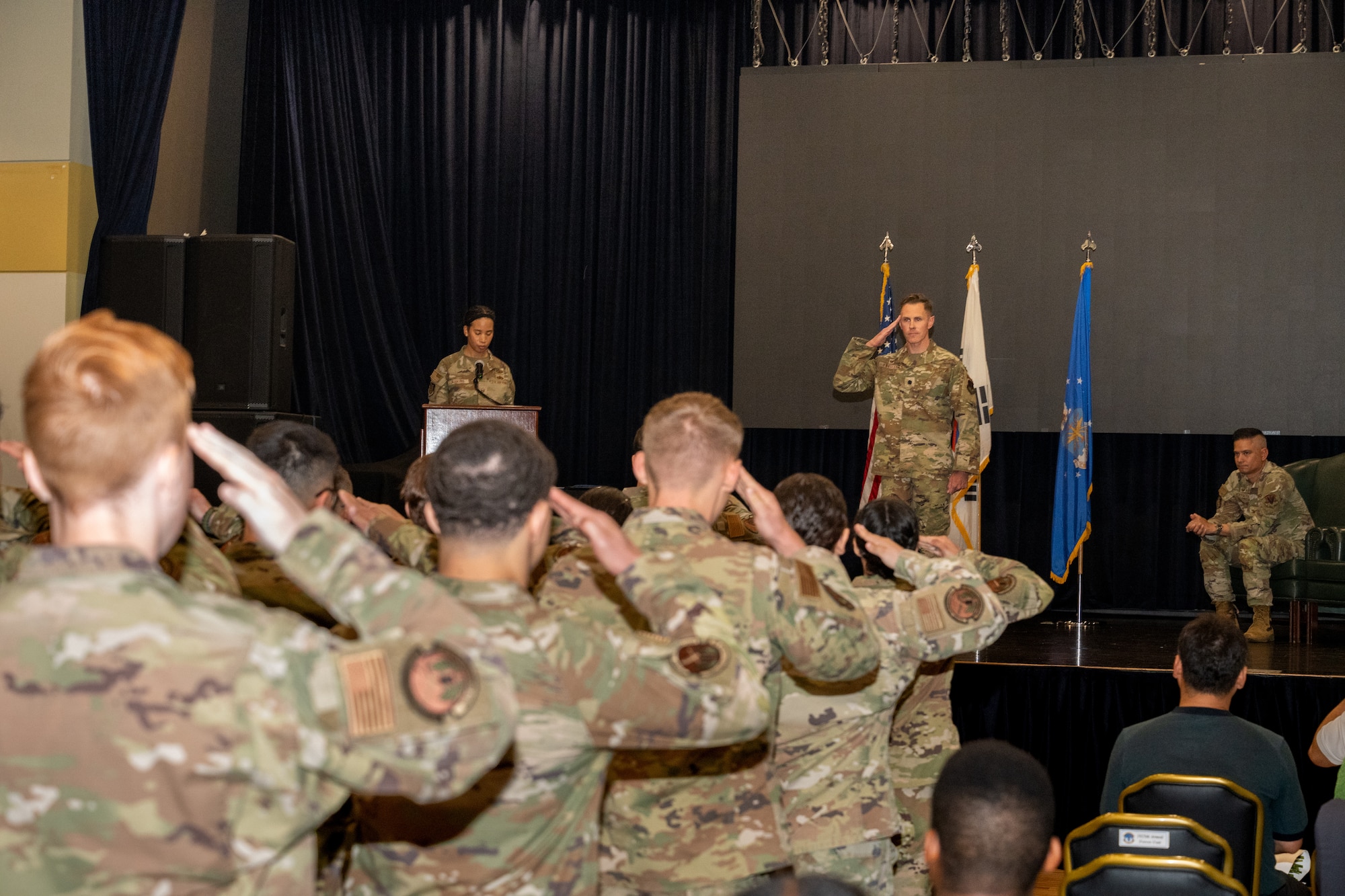 Airmen salute an incoming commander for the first time during a ceremony.
