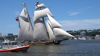 Tall ship Pride of Baltimore II transits the Hudson River during International Naval Review 250 as a U.S. Coast Guard response boat operates nearby and the Royal Moroccan Navy frigate RMNS Mohammed VI (701) is visible in the background. The multinational maritime event commemorates the 250th anniversary of the United States and highlights cooperation among participating maritime forces. (U.S. Navy photo by Lt. Cmdr. Darius A. Radzius)