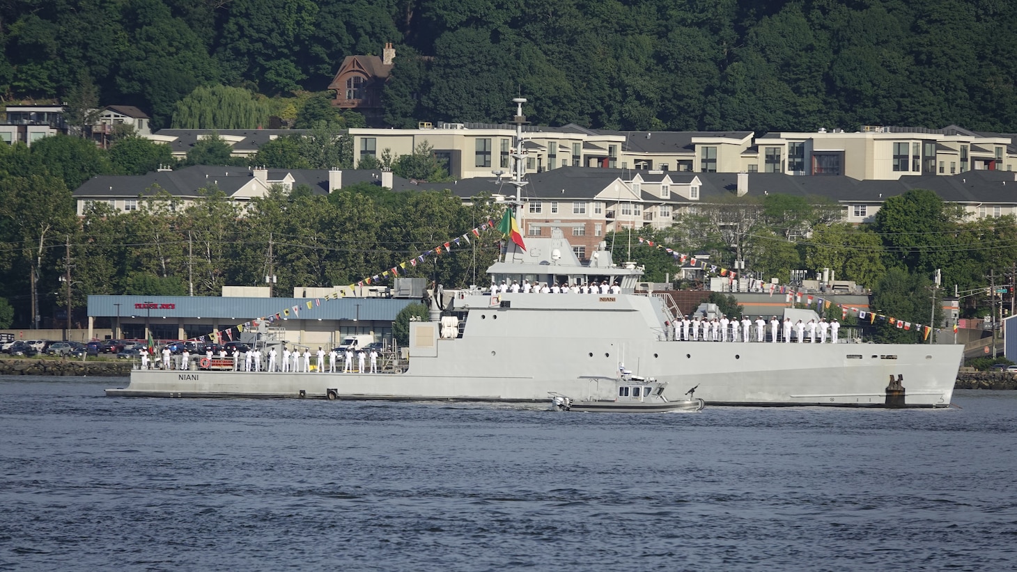 A French Naval Academy sailing vessel displays signal flags as it transits the Hudson River near the Royal Moroccan Navy frigate RMNS Mohammed VI (701) during International Naval Review 250. The multinational maritime event commemorates the 250th anniversary of the United States and highlights cooperation among participating maritime forces. (U.S. Navy photo by Lt. Cmdr. Darius A. Radzius)