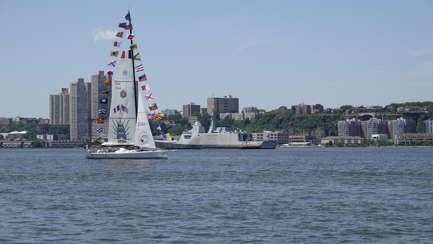 A French Naval Academy sailing vessel displays signal flags as it transits the Hudson River near the Royal Moroccan Navy frigate RMNS Mohammed VI (701) during International Naval Review 250. The multinational maritime event commemorates the 250th anniversary of the United States and highlights cooperation among participating maritime forces. (U.S. Navy photo by Lt. Cmdr. Darius A. Radzius)
