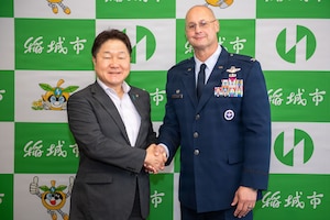 U.S. Air Force Col. Richard McElhaney, 374th Airlift Wing commander, poses for a photo with Katsuhiro Takahashi, mayor of Inagi, at the Inagi City Hall