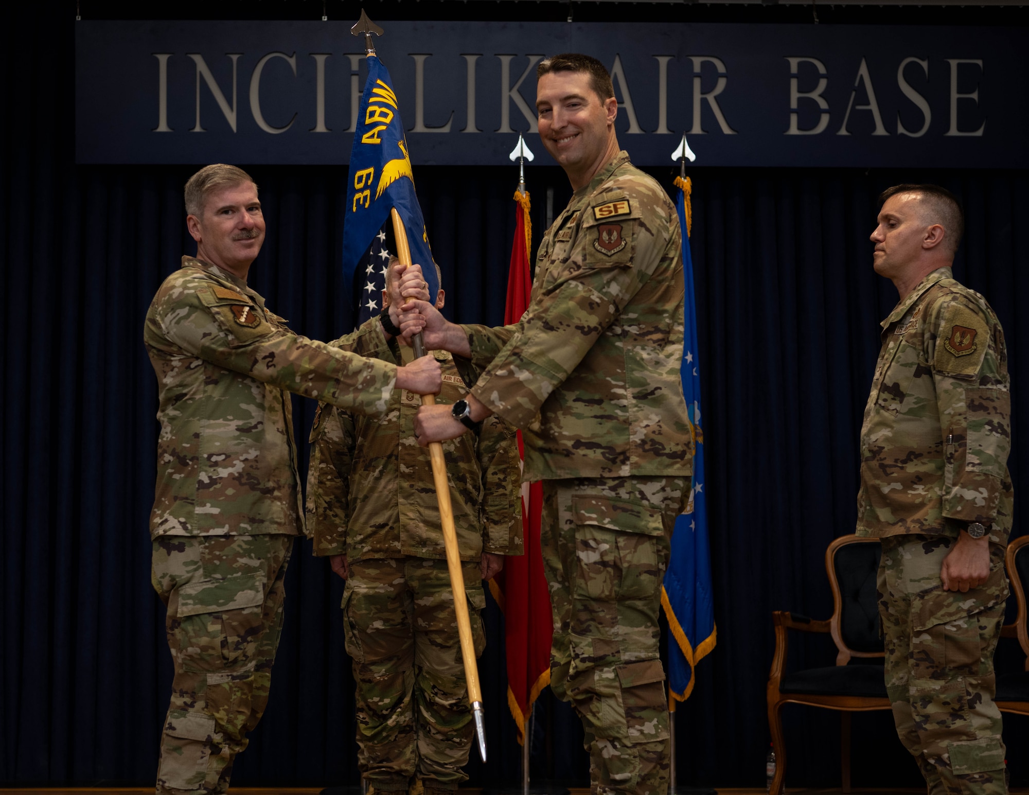 U.S. Air Force Col. Albert Esposito, 39th Air Base Wing commander, passes the guidon to Col. Matthew McGinnis, 39th Weapons System Security Group incoming commander.