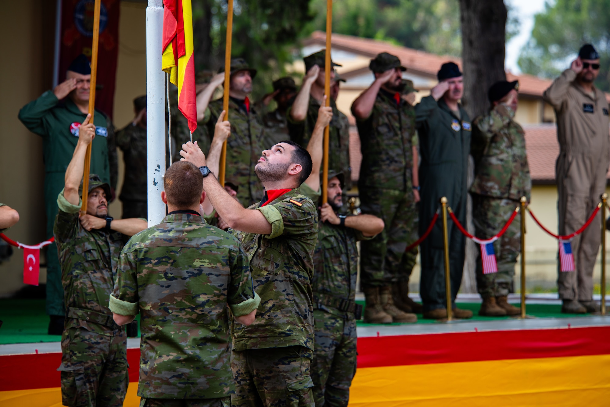 A Spanish army member assigned to the Spanish Patriot Unit raises the Spanish flag.