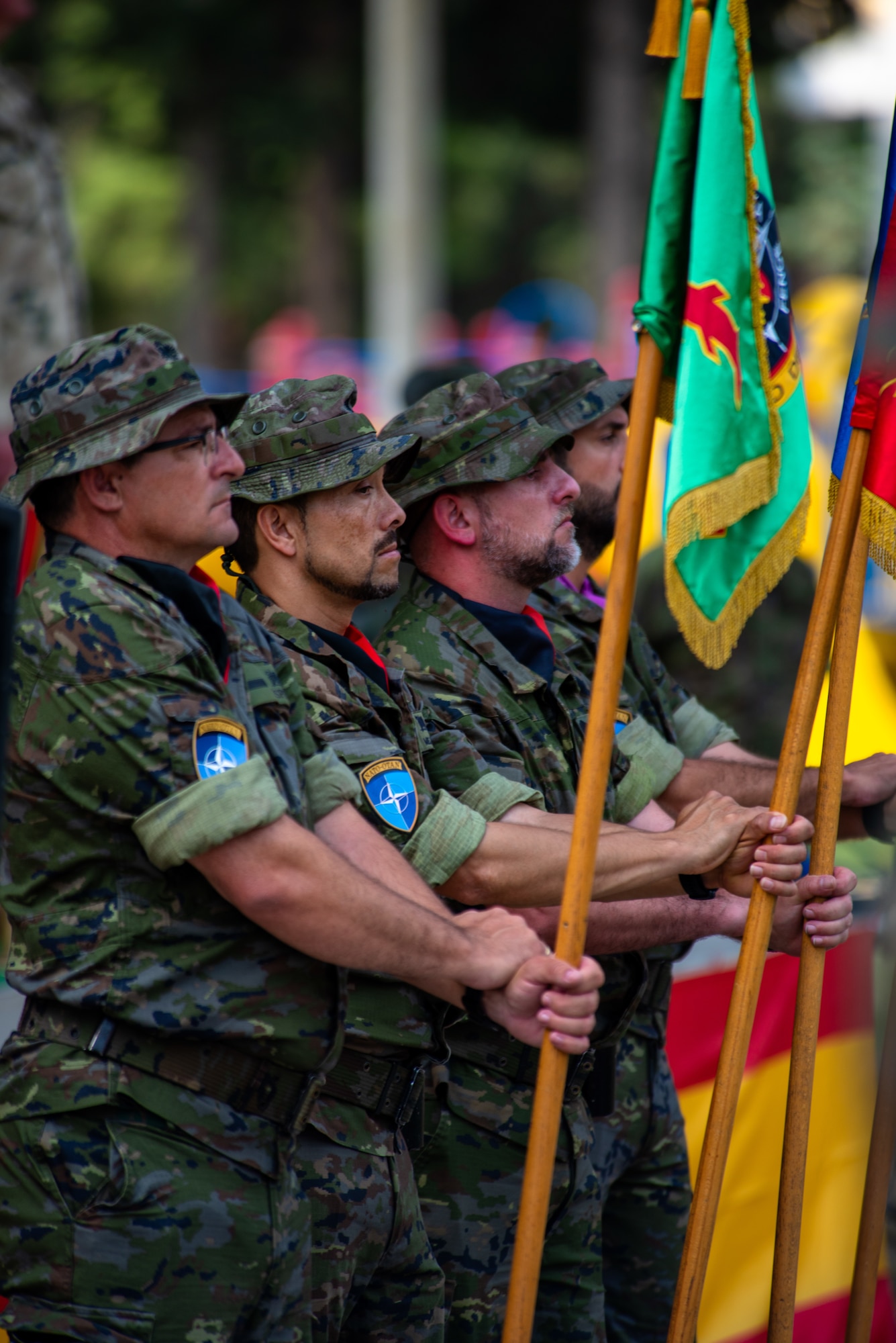 Spanish army members assigned to the Spanish Patriot Unit hold unit colors.