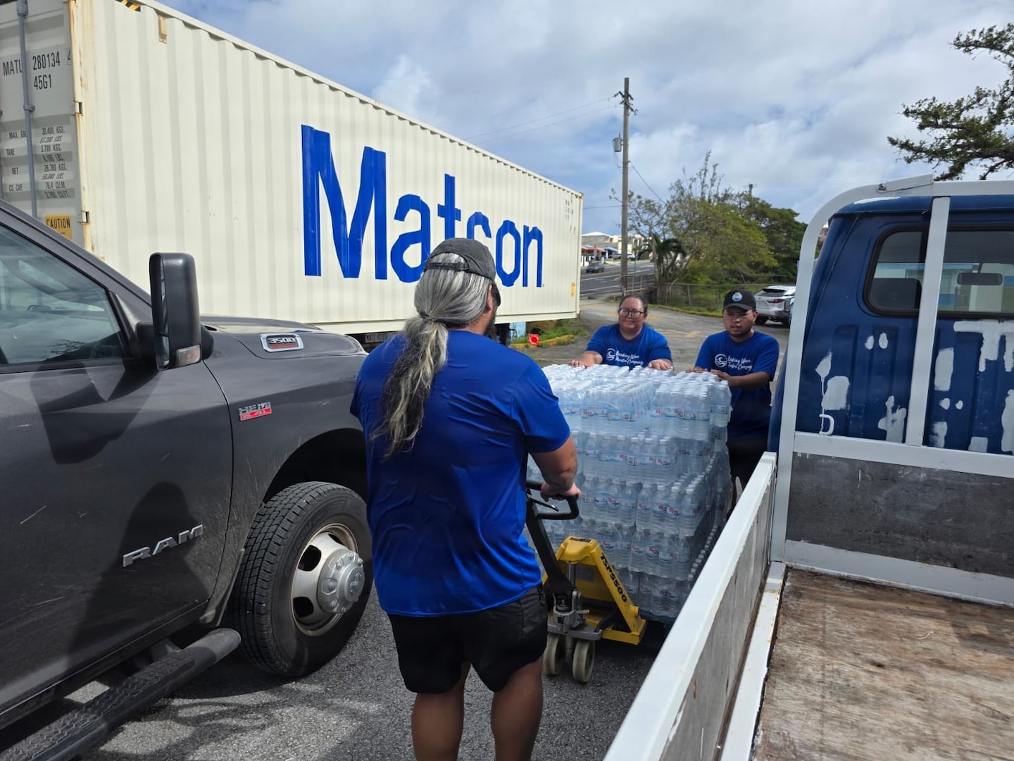 Personnel from U.S. Coast Guard Base Guam and Forces Micronesia/Sector Guam coordinate with the community in Guam to transport pallets of water to a U.S. Coast Guard HC-130J Hercules airplane from Air Station Barbers Point in concert with planned damage assessments of Rota in the Northern Mariana Islands, on July 9, 2026. U.S. Coast Guard crews continue to assess and rectify discrepancies to aids to navigation, waterways, and channel conditions across the Marianas following Super Typhoon Bavi. (U.S. Coast Guard photo by Senior Chief Petty Officer Kevin Reilly)