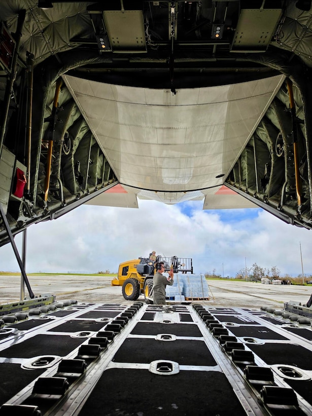 The HC-130J Hercules crew from Air Station Barbers Point in Hawai’i delivers an assessment team and eight pallets of water to Rota, coincident with operations there on July 9, 2026. U.S. Coast Guard crews continue to assess and rectify discrepancies to aids to navigation, waterways, and channel conditions across the Marianas and support the communities following Super Typhoon Bavi. (U.S. Coast Guard photo by Lt. j.g. Nomar Proctor)