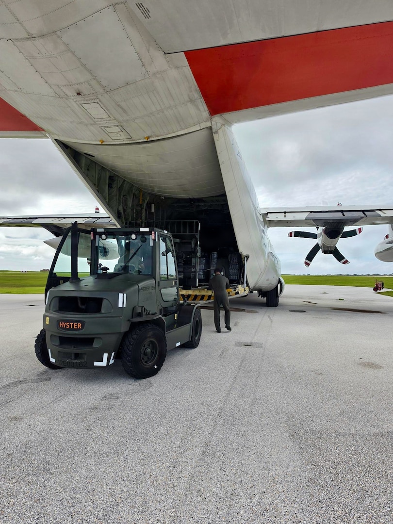 The HC-130J Hercules crew from Air Station Barbers Point in Hawai’i loads up at Andersen Air Force Base and prepares to deliver an assessment team and eight pallets of water to Rota, coincident with operations there on July 9, 2026. U.S. Coast Guard crews continue to assess and rectify discrepancies to aids to navigation, waterways, and channel conditions across the Marianas and support the communities following Super Typhoon Bavi. (U.S. Coast Guard photo by Lt. j.g. Nomar Proctor)