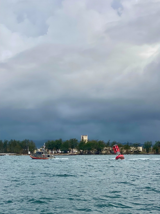 A U.S. Coast Guard Station Apra Harbor 45-foot Response Boat-Medium crew tows Buoy 2 from the entrance of Outer Apra Harbor, Guam, on July 9, 2026. U.S. Coast Guard Forces Micronesia/Sector Guam, Station Apra Harbor, and U.S. Navy Explosive Ordnance Disposal Mobile Unit Five personnel worked together to remove Buoy 2, which moved off station during the storm, into the channel, where vessels expect safe water. (U.S. Navy photo by EODMU5)