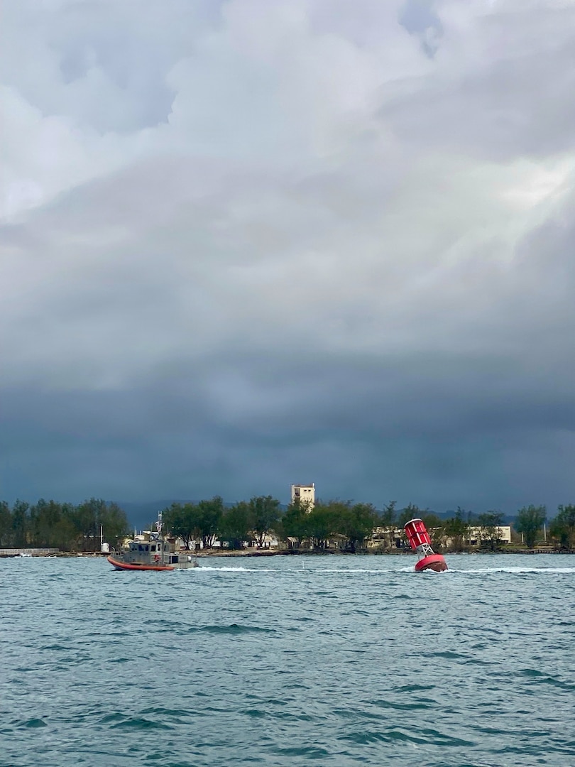 A U.S. Coast Guard Station Apra Harbor 45-foot Response Boat-Medium crew tows Buoy 2 from the entrance of Outer Apra Harbor, Guam, on July 9, 2026. U.S. Coast Guard Forces Micronesia/Sector Guam, Station Apra Harbor, and U.S. Navy Explosive Ordnance Disposal Mobile Unit Five personnel worked together to remove Buoy 2, which moved off station during the storm, into the channel, where vessels expect safe water. (U.S. Navy photo by EODMU5)