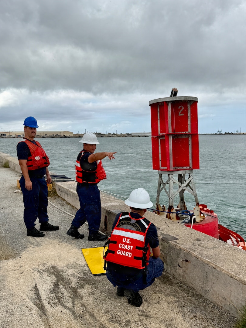U.S. Coast Guard Base Guam, Forces Micronesia/Sector Guam engineering, and Station Apra Harbor 45-foot Response Boat-Medium crew work to secure Buoy 2 at Victor Wharf after its removal from the entrance of Outer Apra Harbor, Guam, on July 9, 2026. U.S. Coast Guard Forces Micronesia/Sector Guam, Station Apra Harbor, and U.S. Navy Explosive Ordnance Disposal Mobile Unit Five personnel worked together to remove Buoy 2, which moved off station during the storm into the channel, where vessels expect safe water. (U.S. Coast Guard photo by Lt. Sara Muir)