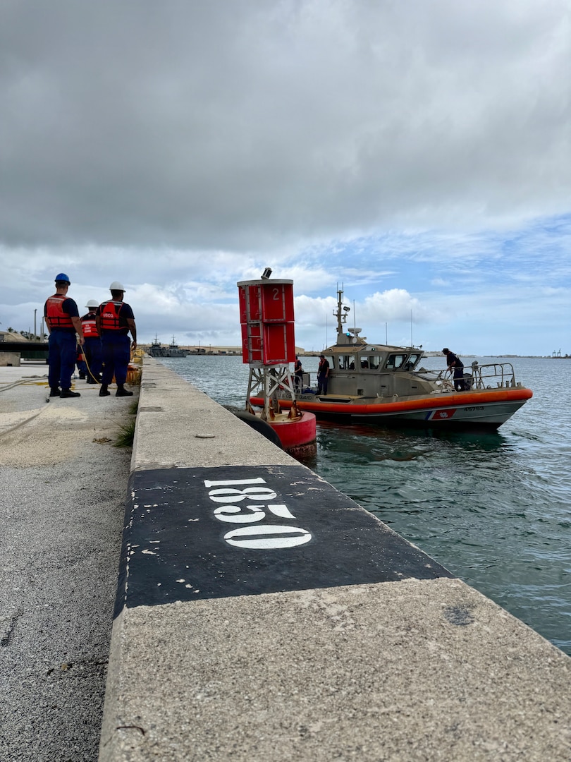 U.S. Coast Guard Base Guam, Forces Micronesia/Sector Guam engineering, and Station Apra Harbor 45-foot Response Boat-Medium crew work to secure Buoy 2 at Victor Wharf after its removal from the entrance of Outer Apra Harbor, Guam, on July 9, 2026. U.S. Coast Guard Forces Micronesia/Sector Guam, Station Apra Harbor, and U.S. Navy Explosive Ordnance Disposal Mobile Unit Five personnel worked together to remove Buoy 2, which moved off station during the storm into the channel, where vessels expect safe water. (U.S. Coast Guard photo by Lt. Sara Muir)