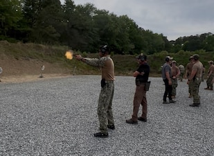 Master-at-Arms 2nd Class Gurjoban Singh, command master-at-arms assigned to Navy Medicine Readiness and Training Command (NMRTC) Twentynine Palms, fires a pistol under the guidance of instructors during Combat Skills Training (CST) in Suffolk, Virginia, June 11, 2026. The weeklong course prepares Expeditionary Medicine Sailors to operate in austere, high-threat environments by strengthening tactical skills, marksmanship and expeditionary readiness. (Courtesy photo).