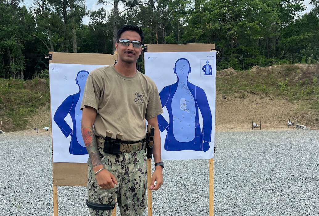 Master-at-Arms 2nd Class Gurjoban Singh, command master-at-arms assigned to Navy Medicine Readiness and Training Command (NMRTC) Twentynine Palms, poses with a target following a live-fire exercise during Combat Skills Training (CST) in Suffolk, Virginia, June 11, 2026. The weeklong course prepares Expeditionary Medicine Sailors to operate in austere, high-threat environments by strengthening tactical skills, marksmanship and expeditionary readiness. (Courtesy photo).