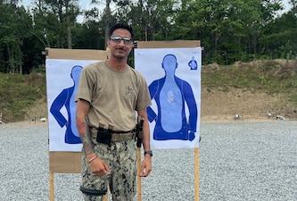 Master-at-Arms 2nd Class Gurjoban Singh, command master-at-arms assigned to Navy Medicine Readiness and Training Command (NMRTC) Twentynine Palms, poses with a target following a live-fire exercise during Combat Skills Training (CST) in Suffolk, Virginia, June 11, 2026. The weeklong course prepares Expeditionary Medicine Sailors to operate in austere, high-threat environments by strengthening tactical skills, marksmanship and expeditionary readiness. (Courtesy photo).