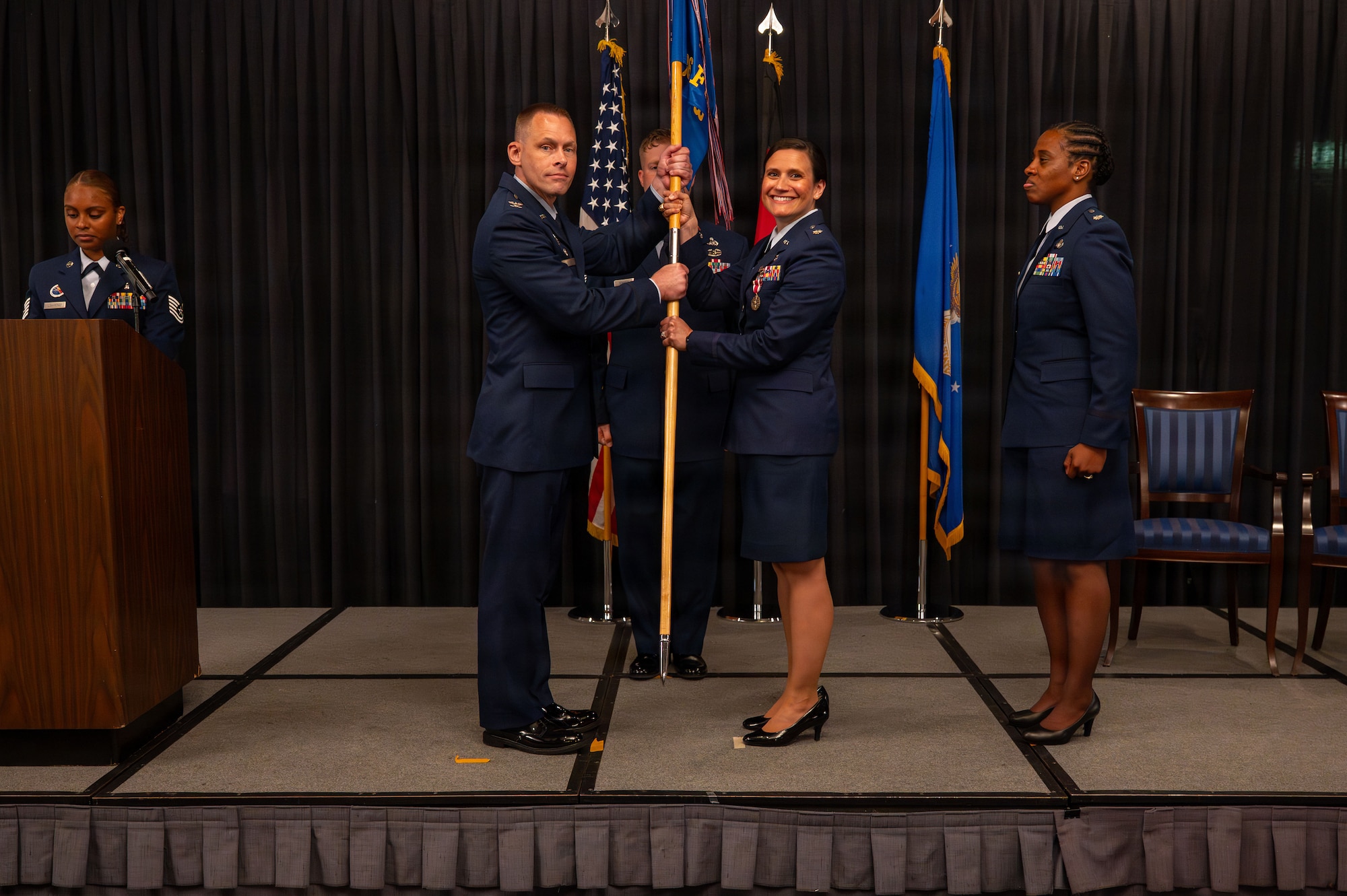 Lt. Col. Katherine C. Kuc, 86th Force Support Squadron outgoing commander, passes the guidon to relinquish command to Col. Jason L. Schenck.