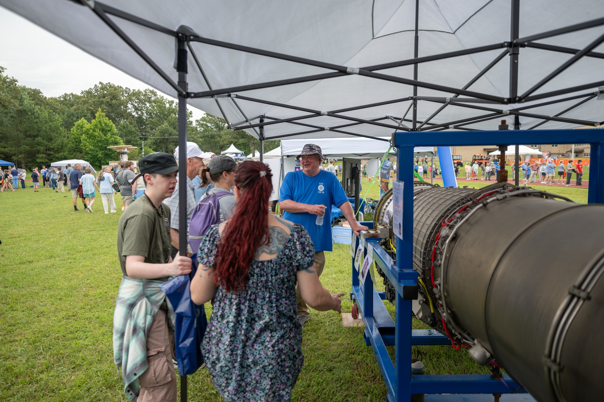 Stephen Arnold, 717th Test Squadron technical adviser, right, discusses an engine on display during the Arnold Engineering Development Complex 75th anniversary open house celebration June 27, 2026, at Arnold Air Force Base, Tenn., headquarters of AEDC. The public open house was held to coincide with the original June 25, 1951, dedication of AEDC. The history and accomplishments of AEDC throughout its first 75 years were showcased during the open house. (U.S. Air Force photo by Keith Thornburgh)