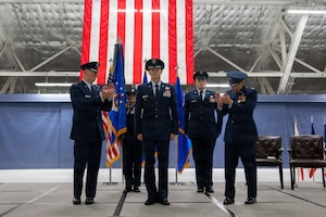 Officers stand and clap on a stage.