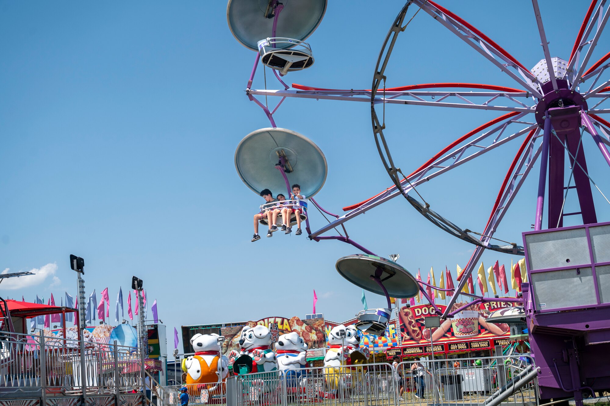 Kids ride a Ferris wheel during Freedom Fest at Joint Base Anacostia-Bolling, Washington, D.C., July 4, 2026. The three-day event featured carnival rides, food trucks and a variety of games and activities to celebrate the nation’s historic birthday. (U.S Air Force photo by Senior Airman Shanel Toussaint)