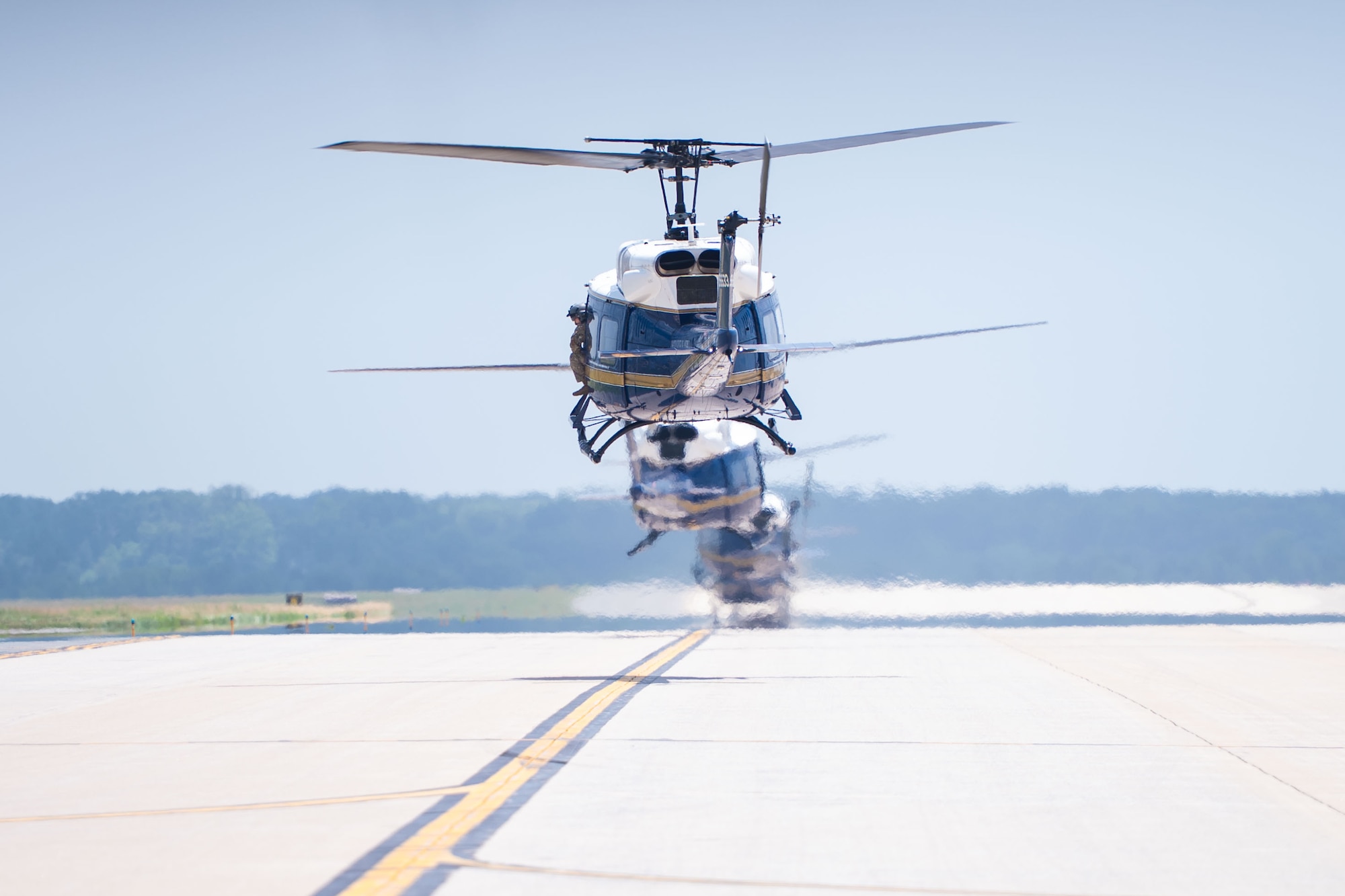 UH-1N Hueys assigned to the 1st Helicopter Squadron taxi during an Elephant Walk
