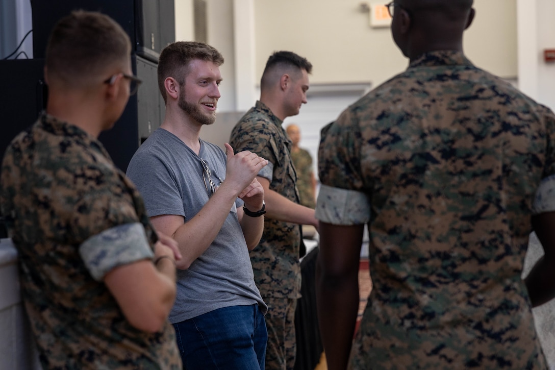 A music teacher with the Educators Workshop speaks to Marines with the Parris Island Band on Marine Corps Recruit Depot Parris Island, May 20, 2026. The Educators Workshop invites educators from all over the Eastern Recruiting Region to visit Parris Island and learn more about the Marine Corps. (U.S. Marine Corps photo by Lance Cpl. Nicholas White)