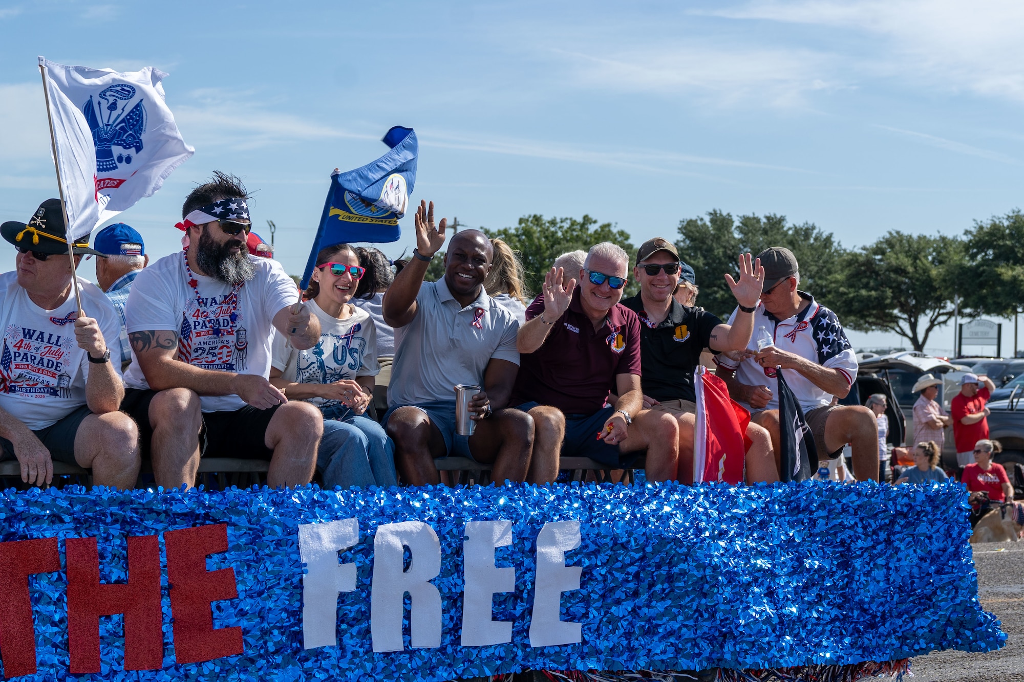 People are waving while on a parade float