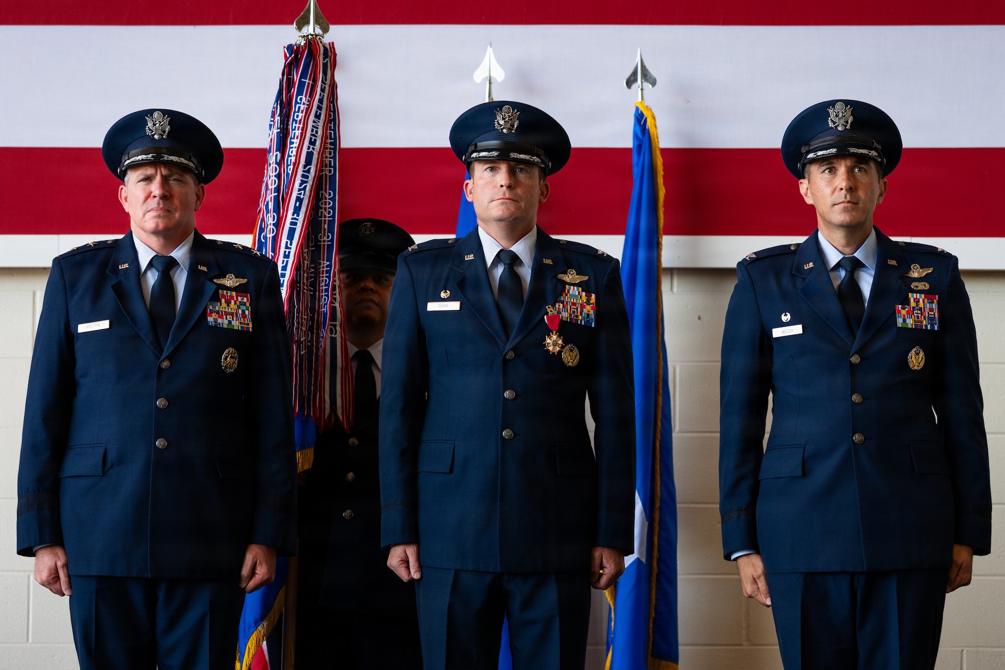 From left, U.S. Air Force Maj. Gen. Charles Bolton, Eighteenth Air Force commander, presides over the 317th Airlift Wing change of command ceremony alongside outgoing commander Col. Justin Diehl and incoming commander Col. Christopher Welch at Dyess Air Force Base, Texas, July 8, 2026. As the presiding officer, Bolton officially transferred authority of the wing, ensuring the continuous, lethal readiness of the largest C-130J Super Hercules wing. (U.S. Air Force photo by Senior Airman Jade M. Caldwell)