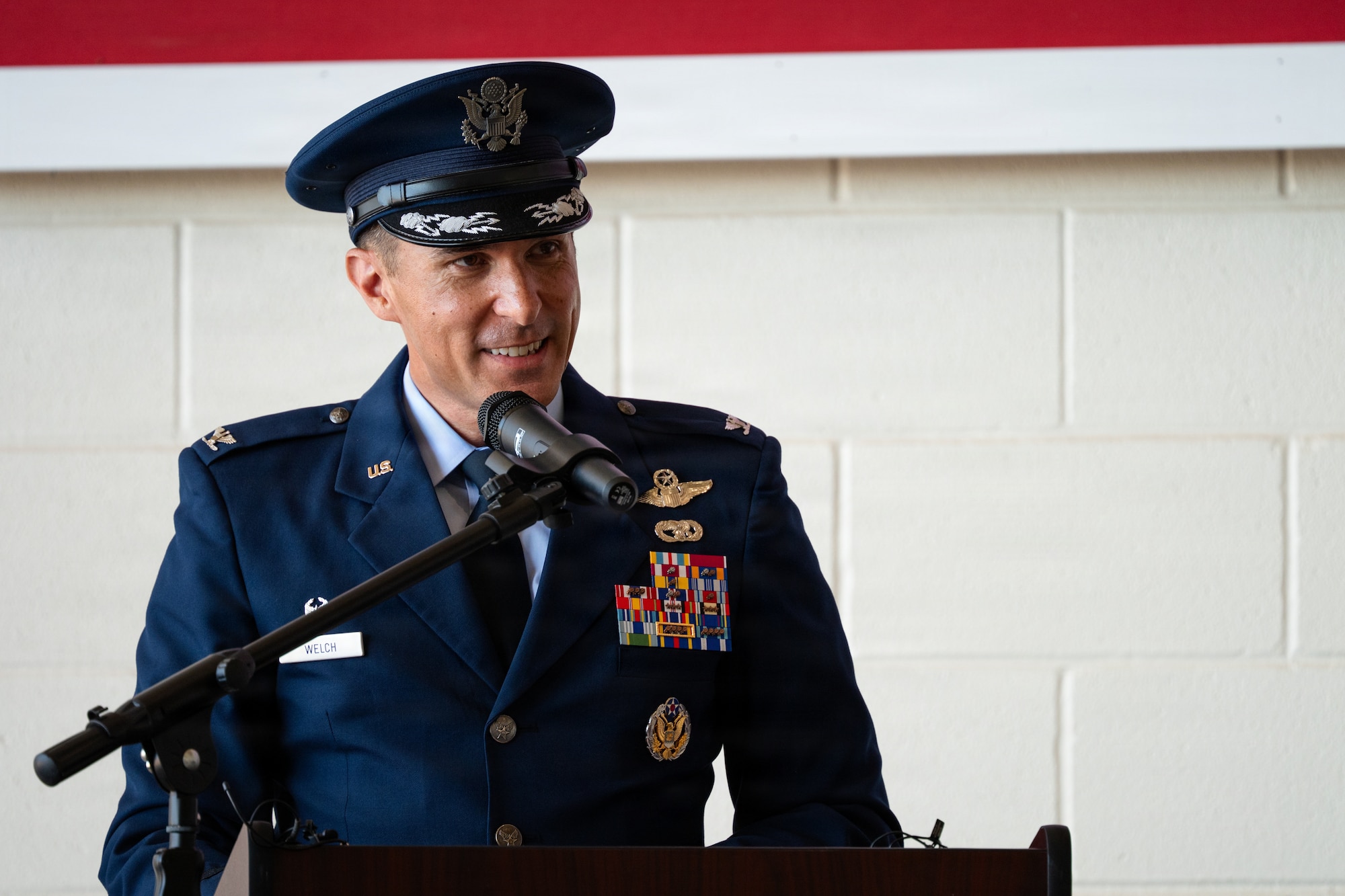 U.S. Air Force Col. Christopher Welch, incoming 317th Airlift Wing commander, delivers his first address to the wing during a change of command ceremony at Dyess Air Force Base, Texas, July 8, 2026. Welch is a senior pilot with over 3,300 flight hours in the KC-10A Extender and C-130J Super Hercules, including 1,300 combat hours across multiple operations. As the 317th AW commander, Welch will lead the world's largest fleet of C-130J, projecting rapid, tactical global mobility in contested environments (U.S. Air Force photo by Senior Airman Jade M. Caldwell)