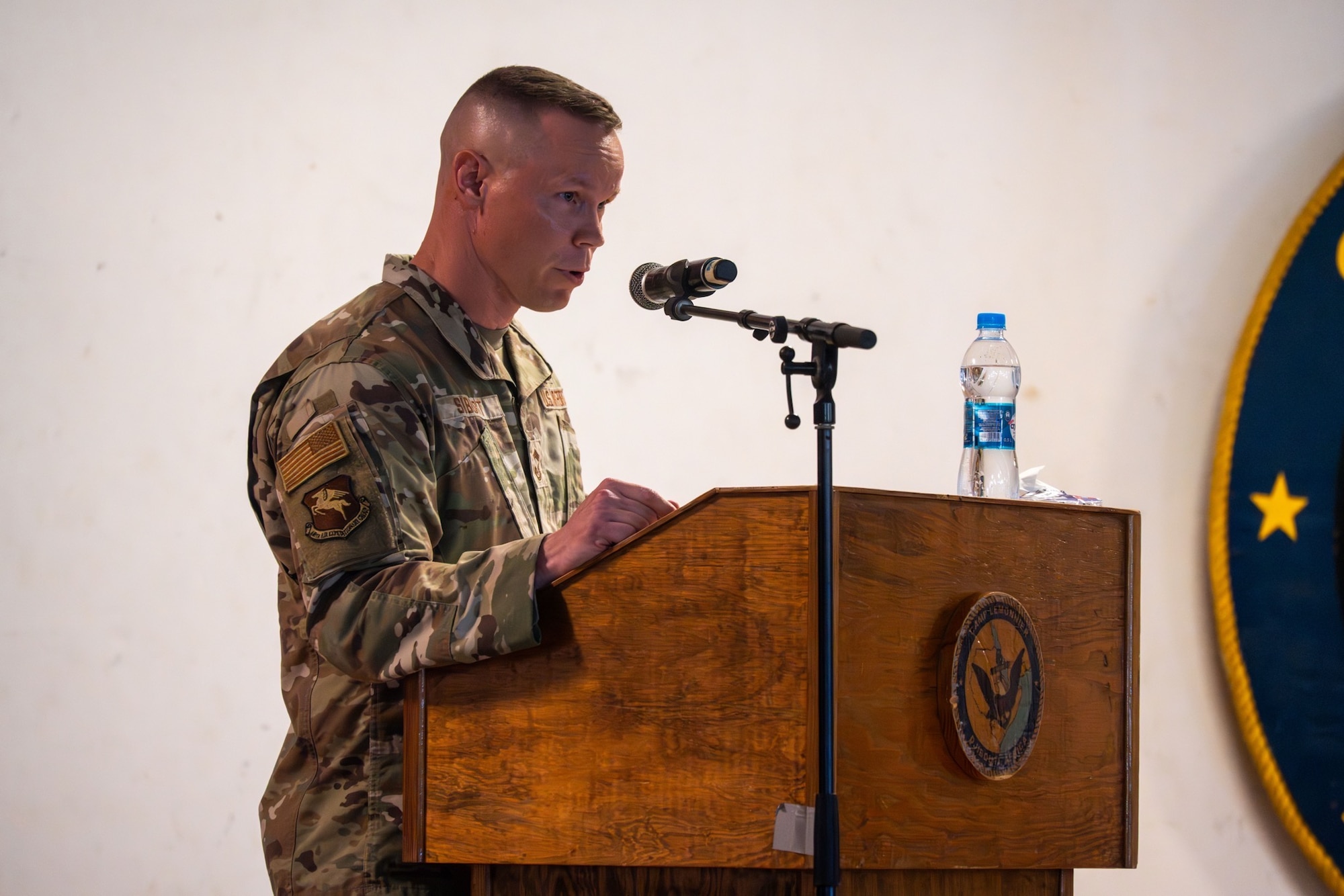 U.S. Air Force Chief Master Sgt. Nicholas Siburt, 449th Air Expeditionary Group outgoing senior enlisted leader, gives his last remarks before the 449th AEG Change of Responsibility ceremony at Camp Lemonnier, Djibouti, June 18, 2026. The 449th AEG provides personnel recovery task forces, intra-theater airlift, base operating support integrator, intelligence, surveillance, and reconnaissance capabilities, and aircraft launch and recovery elements in support of U.S. Central Command and U.S. Africa Command mission requirements, including support to regional partners. (U.S. Air Force photo by Senior Airman Luis Gomez)
