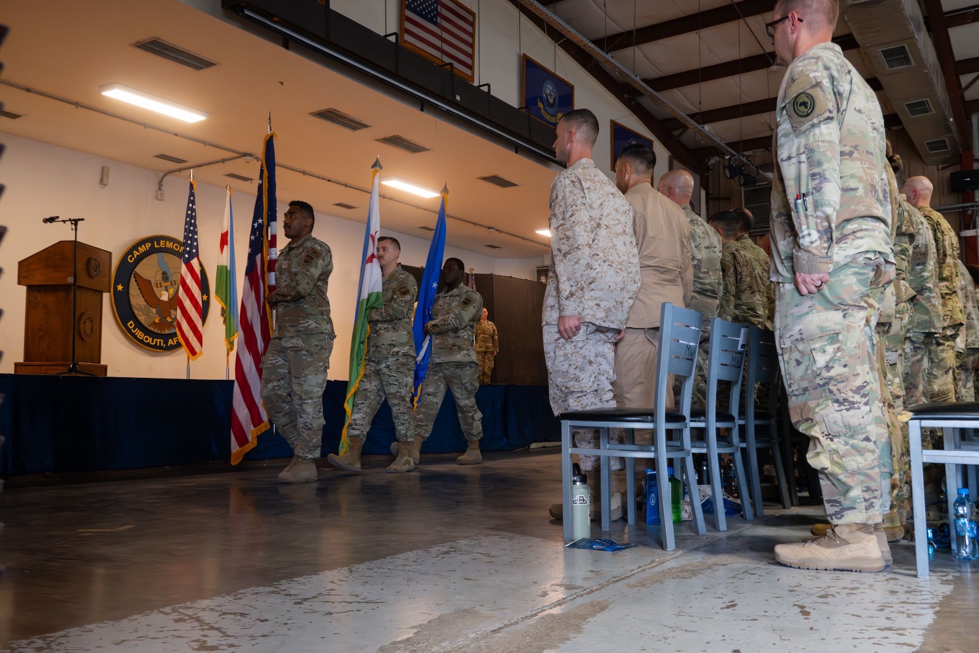 U.S. Air Force Honor Guard march out to present the Colors at the start of the 449th Air Expeditionary Group Change of Responsibility ceremony at Camp Lemonnier, Djibouti, June 18, 2026. The 449th AEG serves as the Joint Air Component Coordination Element to Combined Joint Task Force-Horn of Africa and in partnership with joint, interagency, intergovernmental, and multinational teammates, the 449th AEG also engages in theater security cooperation activities. (U.S. Air Force photo by Senior Airman Luis Gomez)